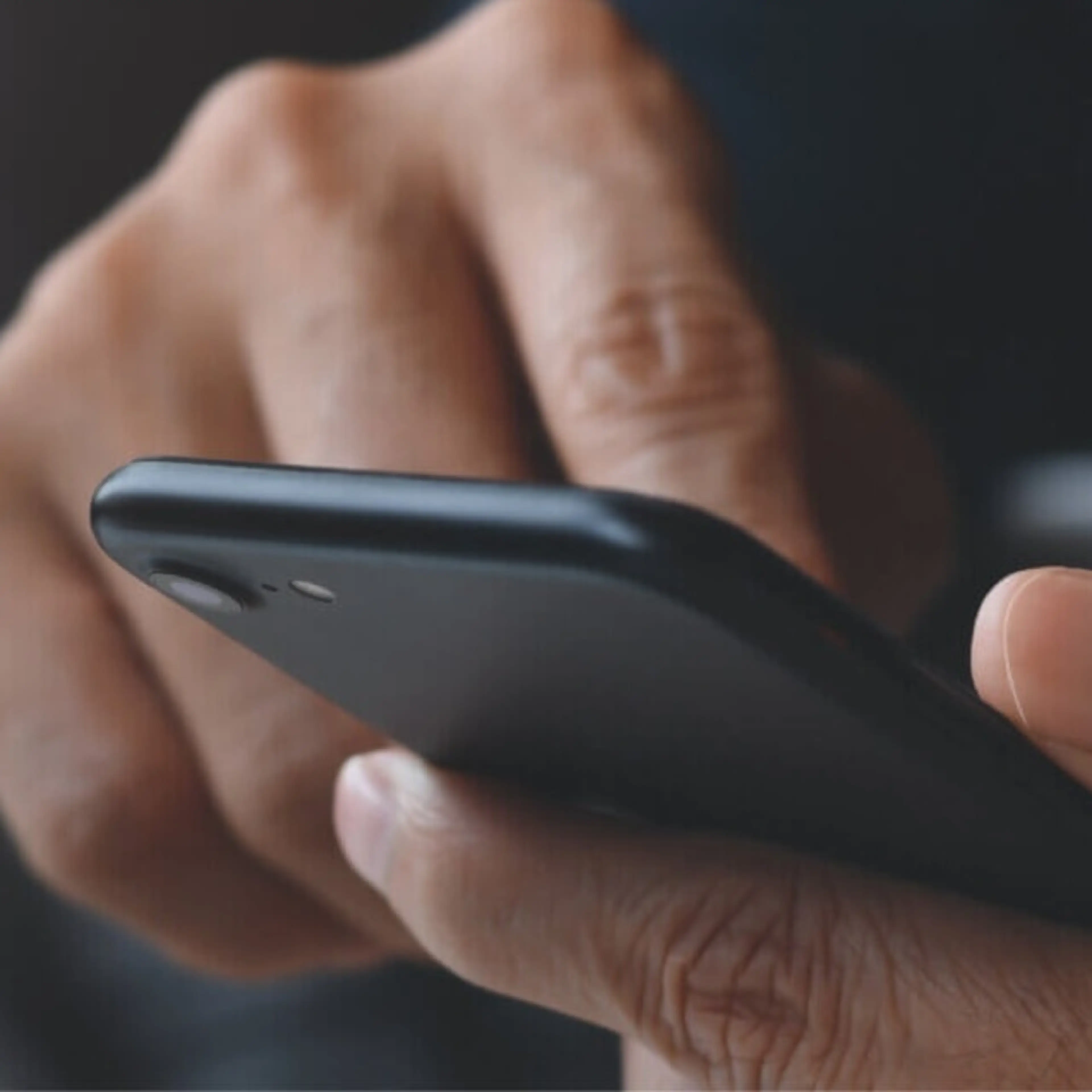 Hands holding a mobile phone