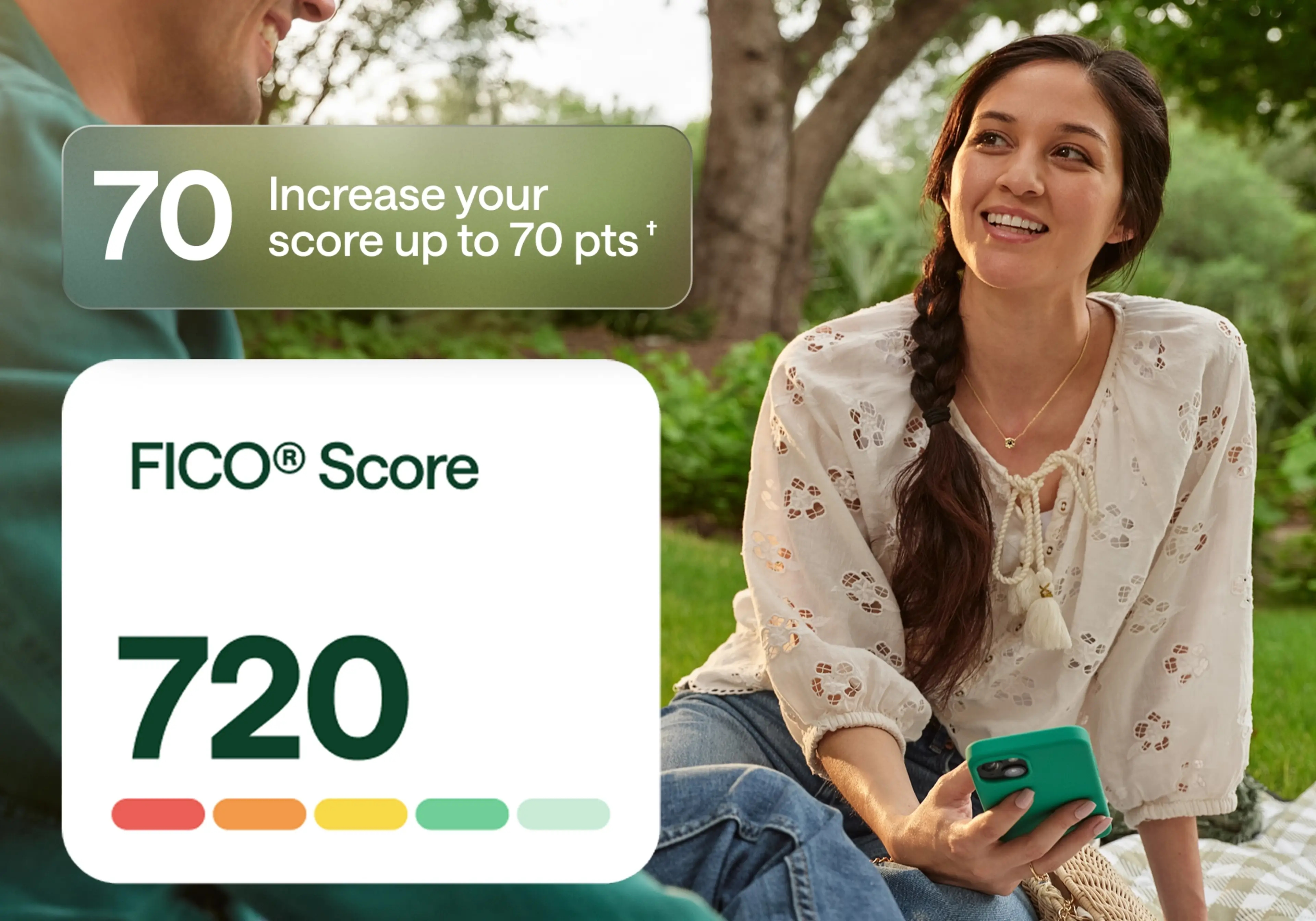 A woman sitting outdoors on a picnic blanket, smiling and holding a cellphone. A graphic overlay on the left shows a FICO® Score of 720 and a message that reads: “Increase your score up to 70 pts.” The image promotes Chime’s credit-building feature.
